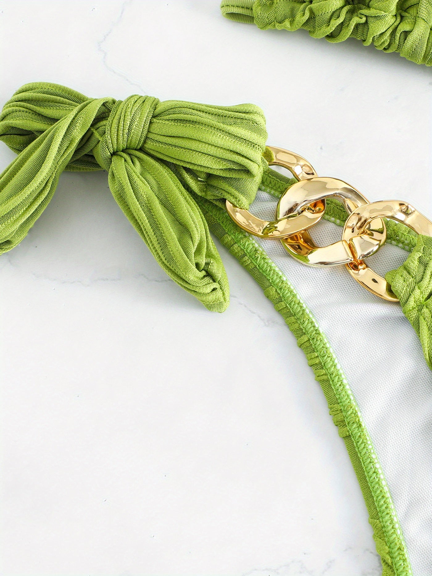 Green striped bikini bottom with bow tie and gold ring-link side detail