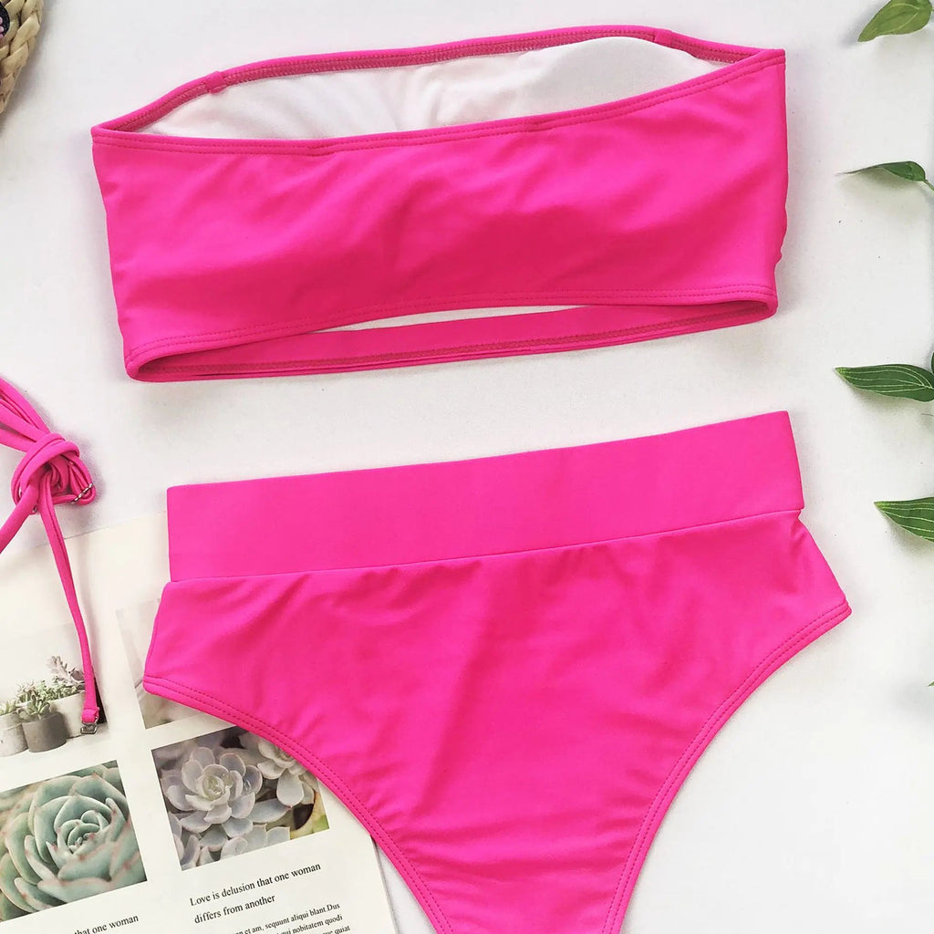 Rose red bandeau bikini set with high-waisted bottoms and gold medallion buckle