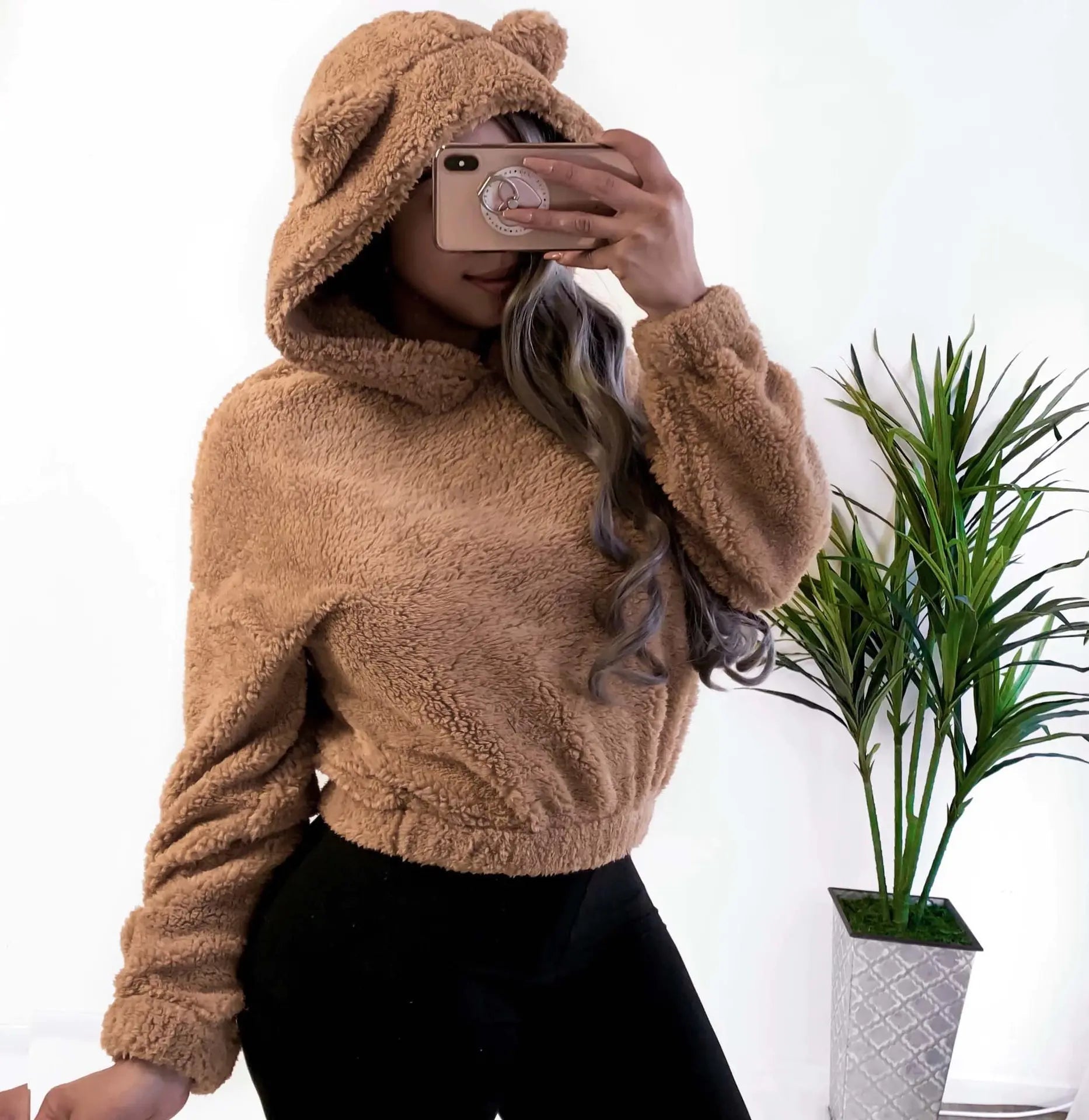 Tan fluffy hooded sweatshirt with long sleeves and front kangaroo pocket
