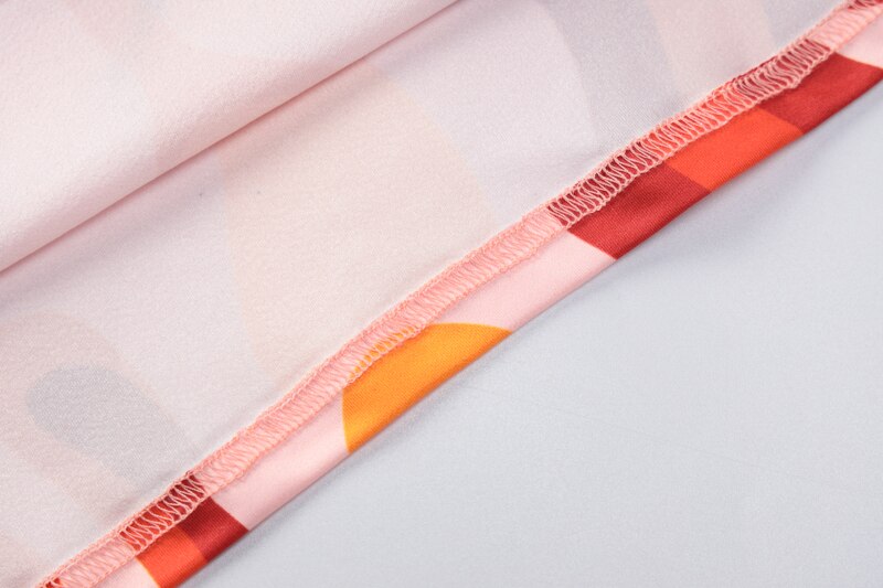 Printed garment cuff edge with multicolor swirl trim and stitched seam