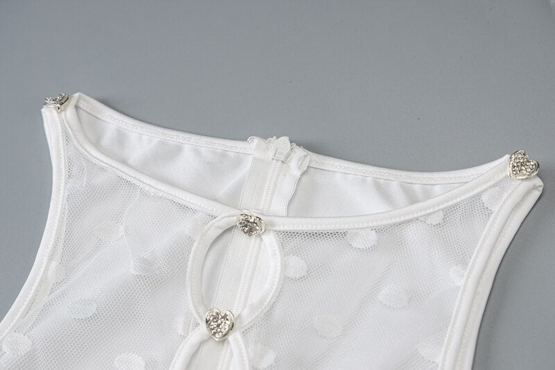 White sheer bodysuit back with mesh overlay and heart-shaped metallic strap buttons