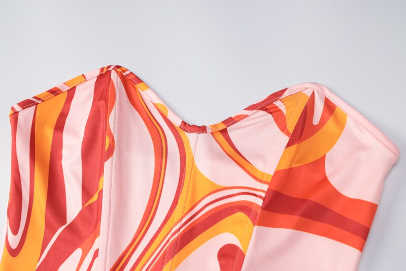 Close-up of swirl-printed strapless neckline on a mini dress