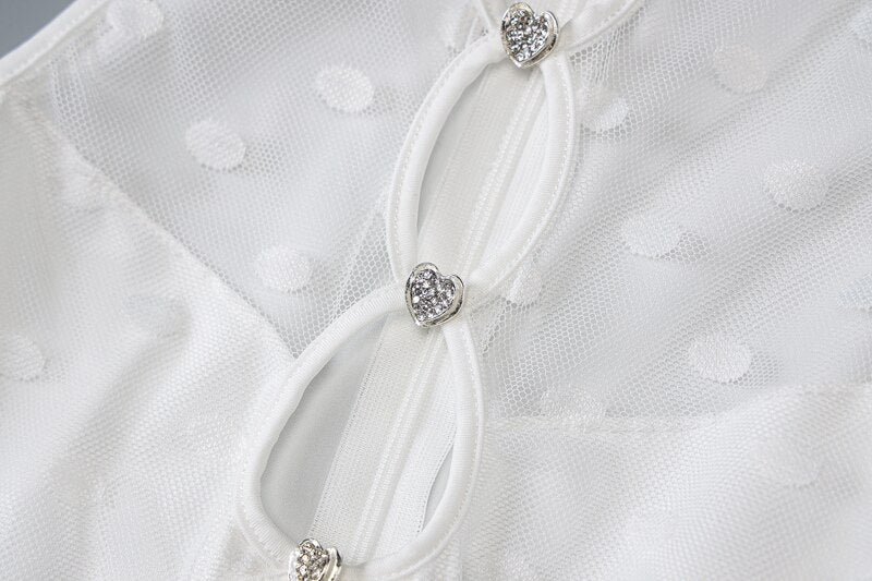 White sheer bodysuit with heart-shaped metallic details on connected front straps