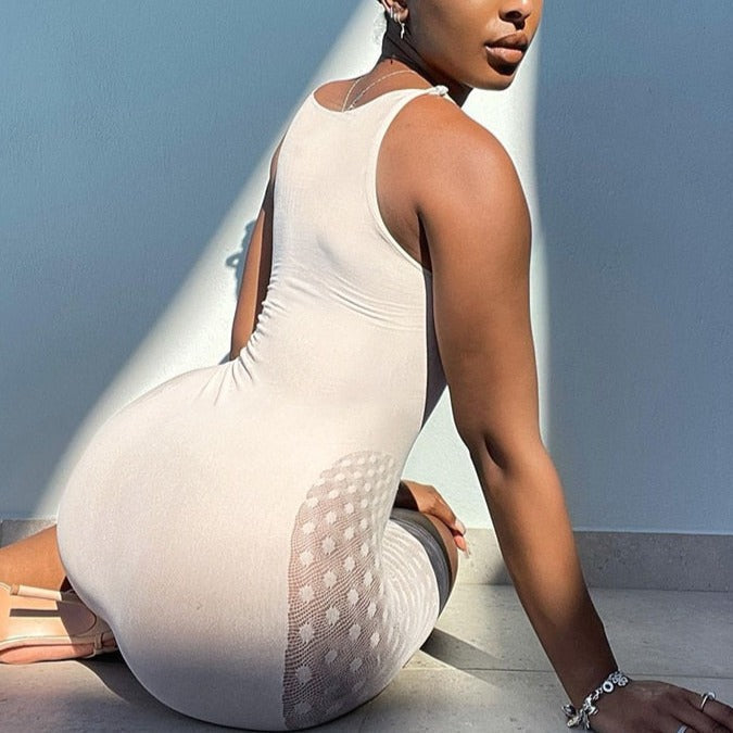 White sleeveless bodysuit with oval back cutouts and high neckline