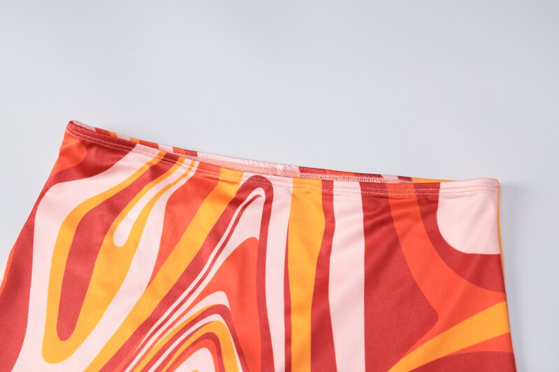 Close-up of swirl-printed skirt fabric panels on a mini dress