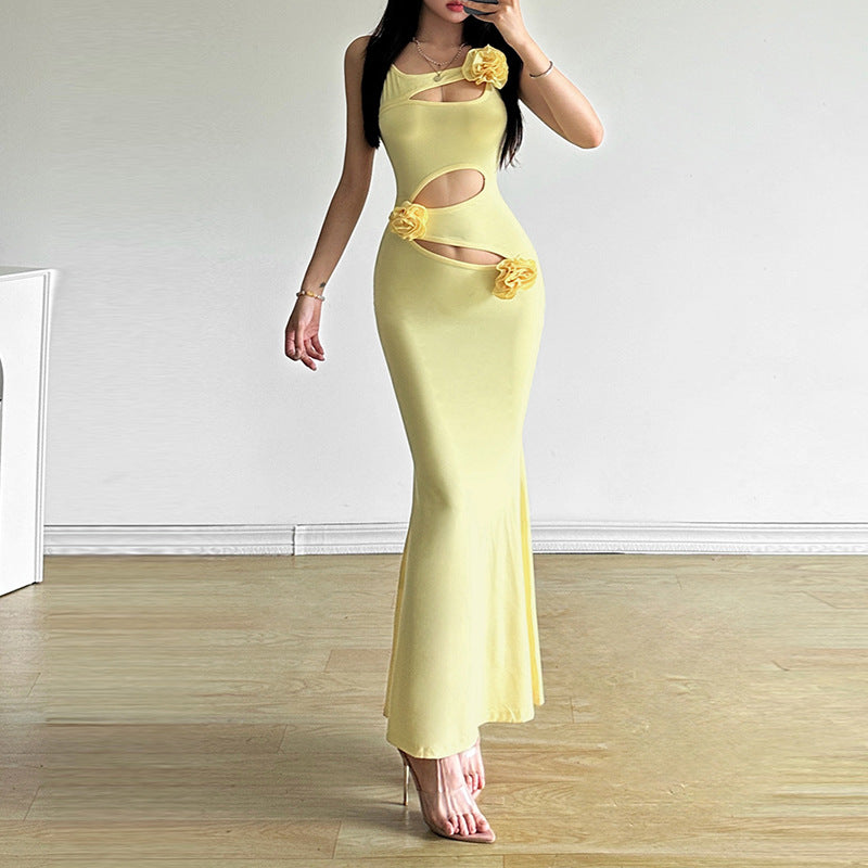 Yellow mermaid maxi dress with side cutouts and flower accents on bodice