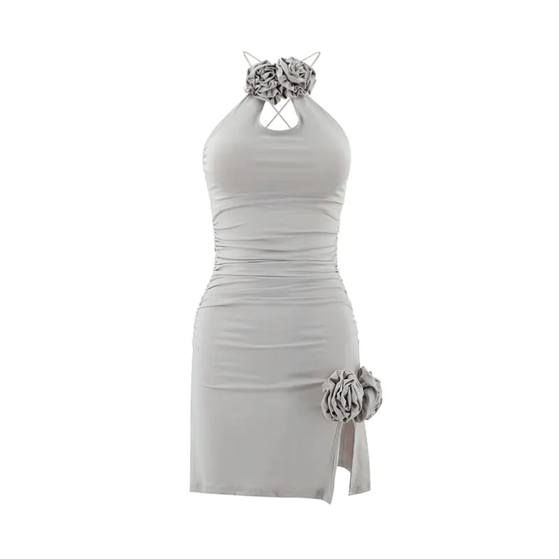 Light halter mini dress with bow neckline, ruched fit, and rose applique at hem