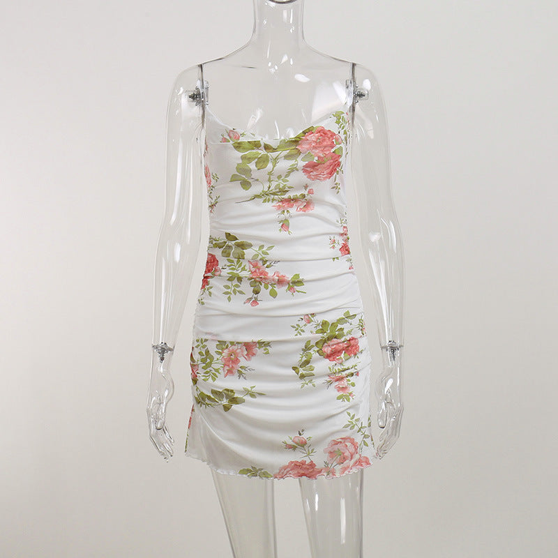 White floral mini dress on mannequin, ruched bodice and fitted skirt