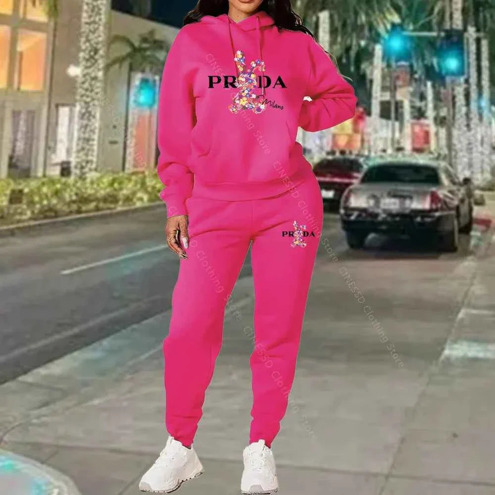 Women's 2-piece hoodie and jogger set, hot pink with PRADA logo on chest and pants.