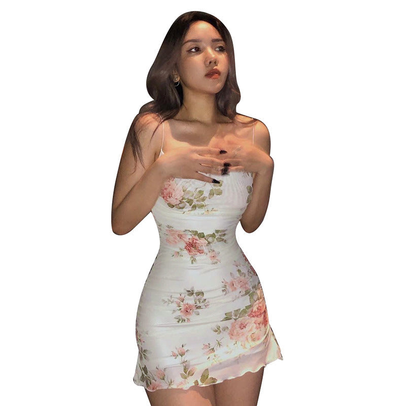 White floral mini dress with spaghetti straps and fitted ruched silhouette