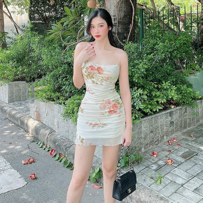 White floral ruched mini dress with spaghetti straps and straight neckline