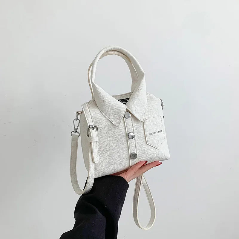 White mini handbag with top handle and wrist strap, button front, and front patch pocket