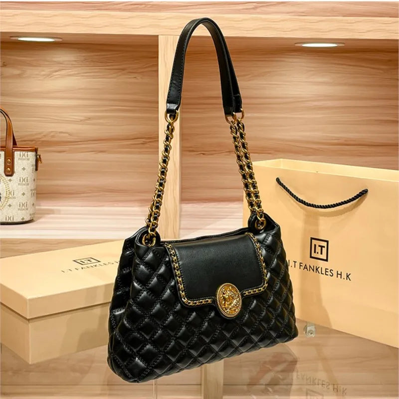 Black quilted shoulder bag with gold chain strap and round gold medallion front clasp