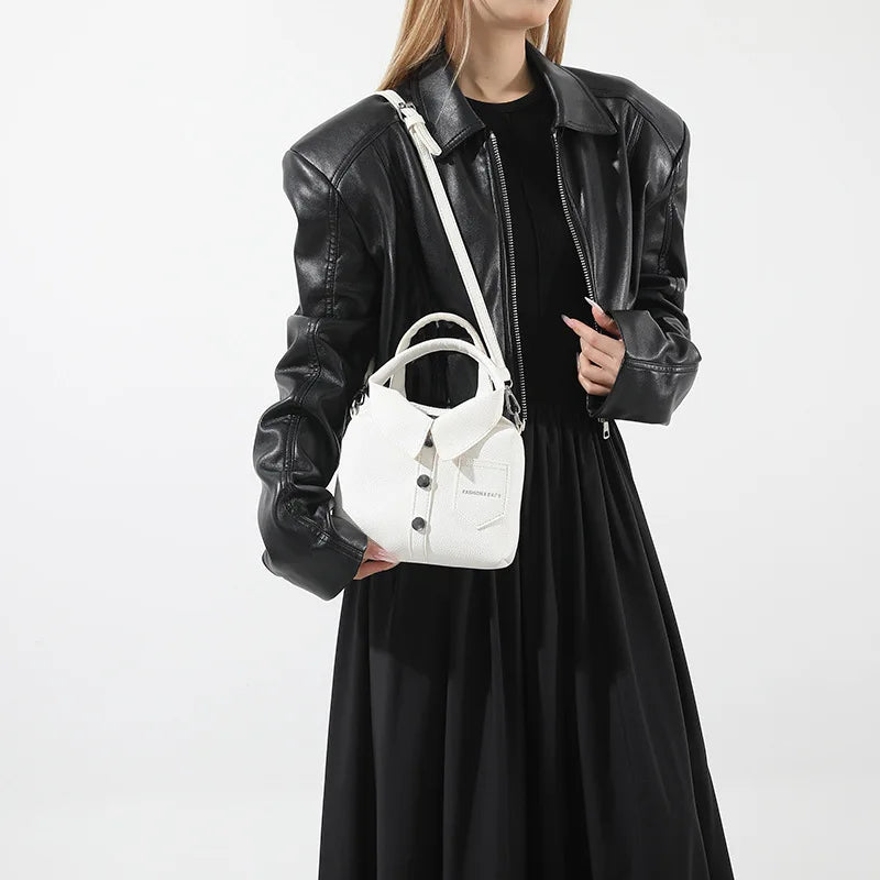 White textured mini bag with button-front collar, front pocket, and crossbody strap