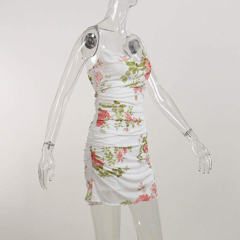 White floral ruched mini dress on mannequin with spaghetti straps