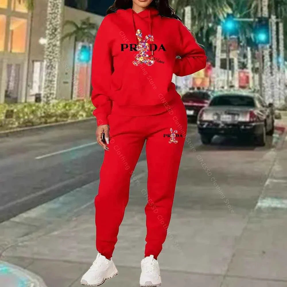 Women's 2-piece hoodie and jogger set, red with PRADA logo on chest and pants.