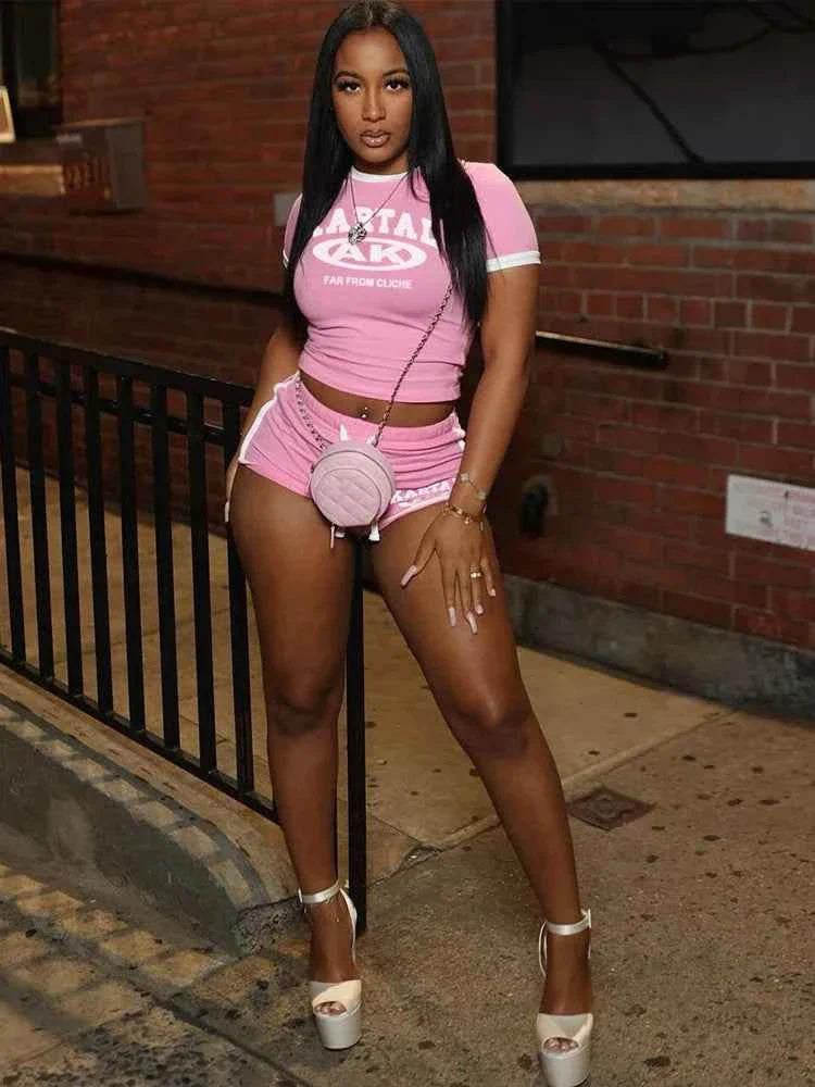 Pink cropped T-shirt and matching shorts set with white trim and KARTAL AK logo.