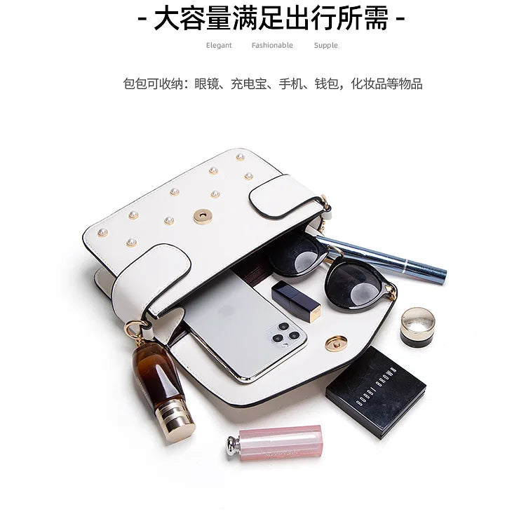 White studded flap crossbody bag open with phone and accessory compartments