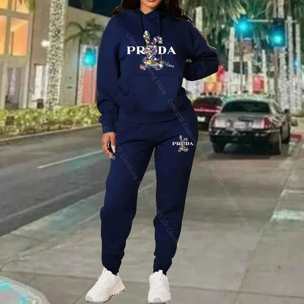 Women's 2-piece hoodie and jogger set, navy blue with PRADA logo on chest and pants.