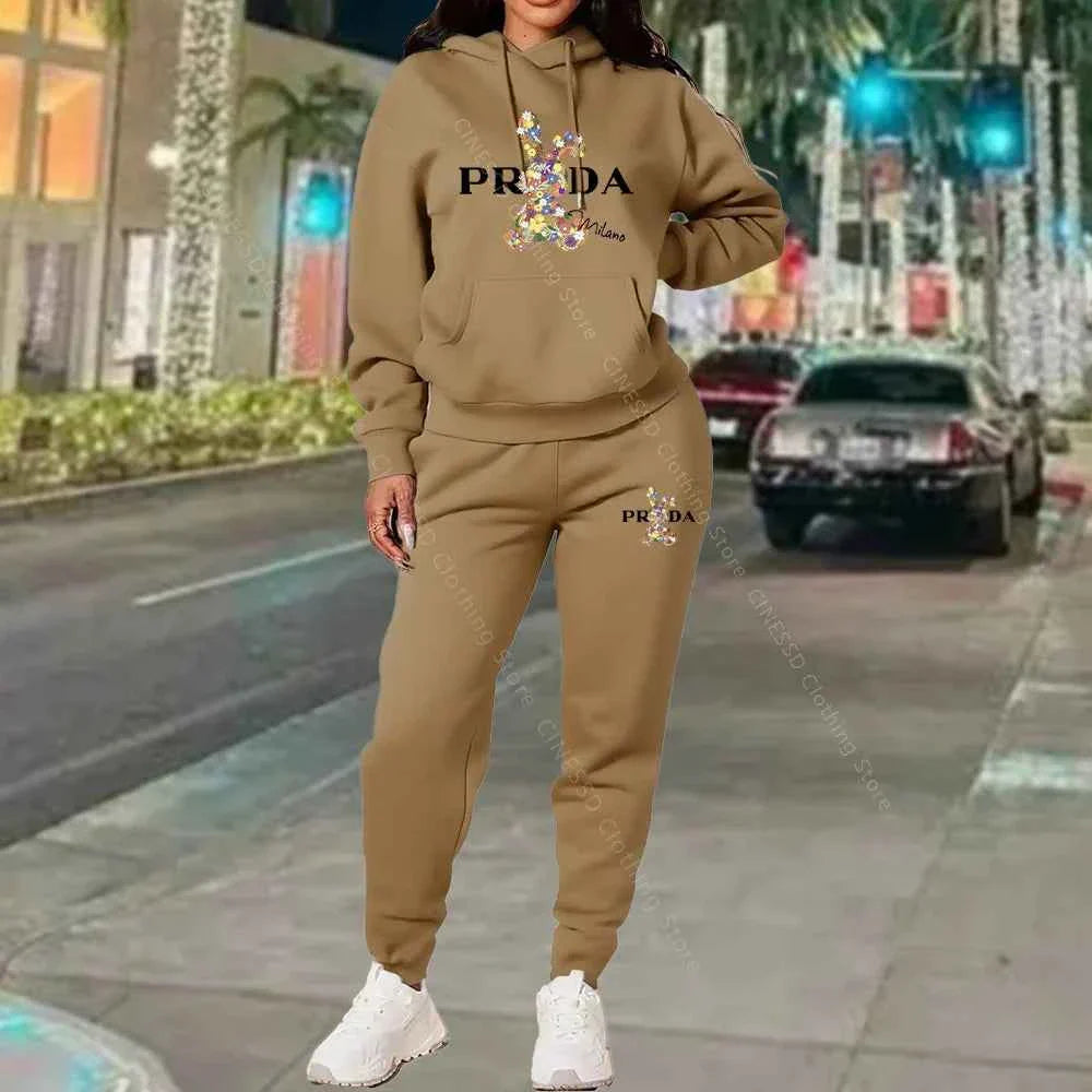 Women's 2-piece hoodie and jogger set, tan/beige with PRADA logo on chest and pants.
