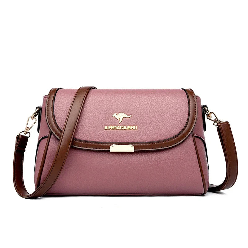 Pink textured crossbody bag with top flap and adjustable shoulder strap