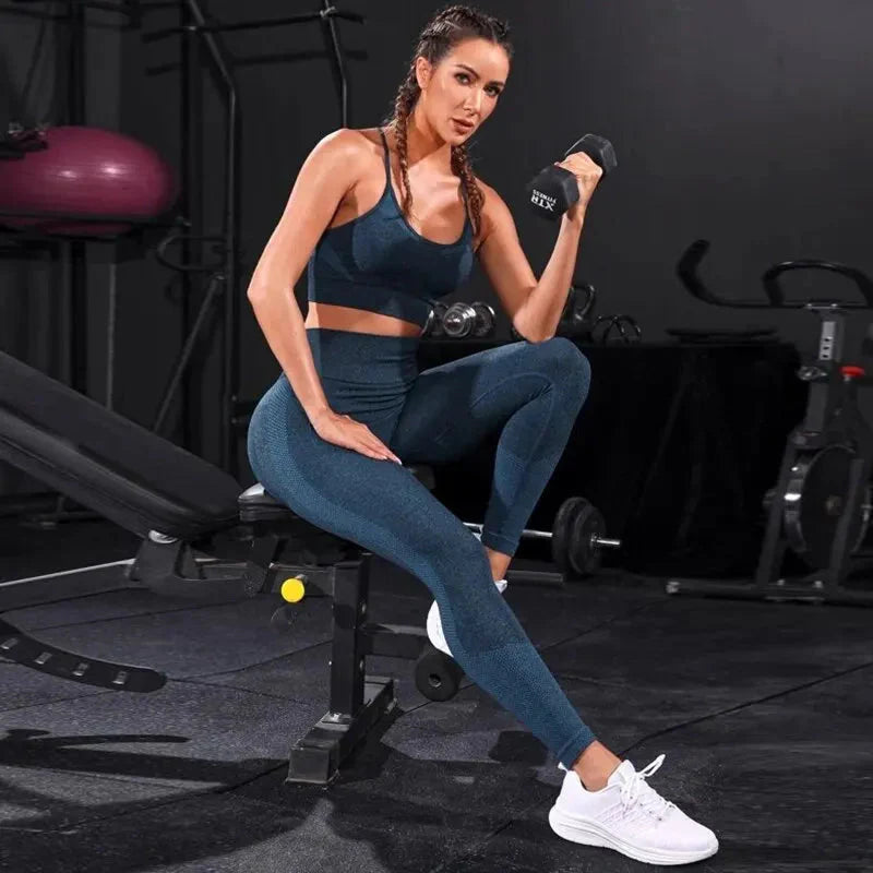 Blue strappy sports bra and high-rise leggings set, seated pose