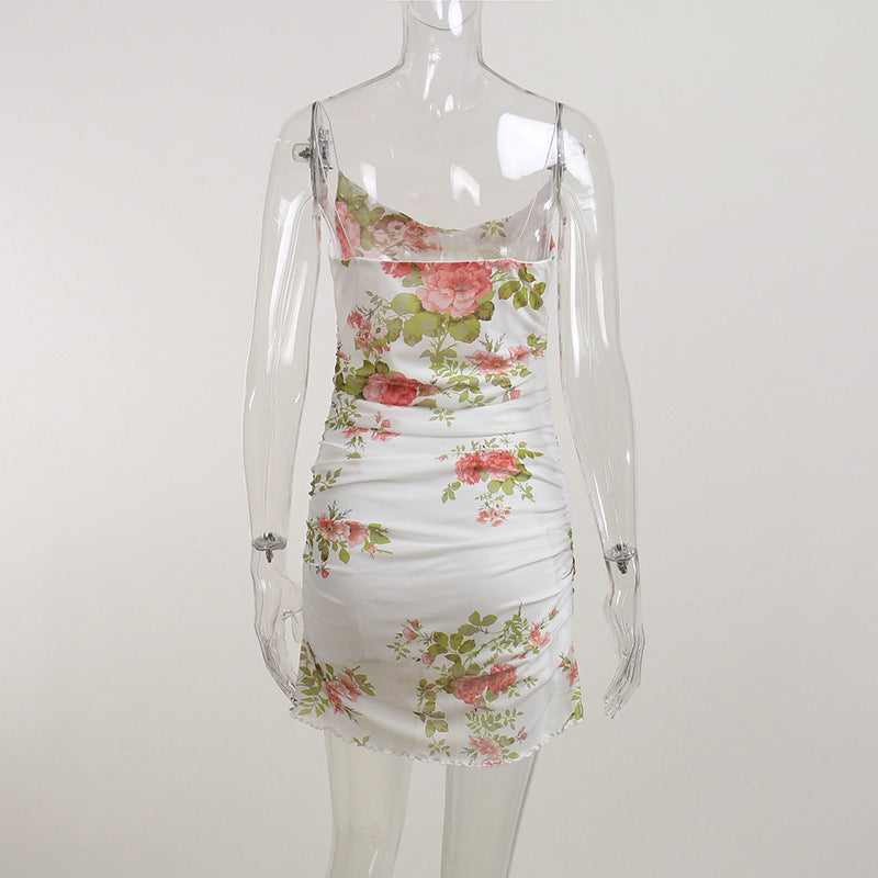 White floral ruched mini dress on mannequin with allover rose-and-leaf print