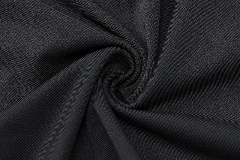 Black sheer knit fabric with gathered fold detail, close-up