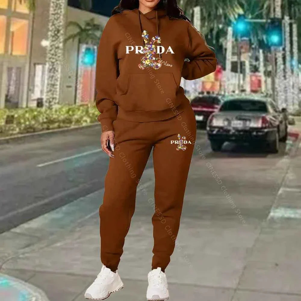Women's 2-piece hoodie and jogger set, brown with PRADA logo on chest and pants.
