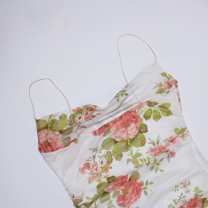 White floral slip dress with spaghetti straps and fitted ruched bodice, short length