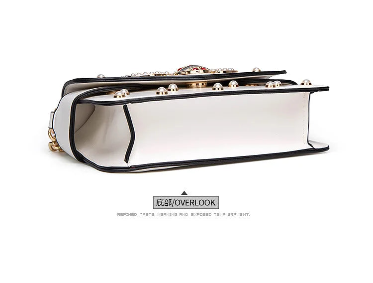 White flap handbag shown from the side with black-trim lining and top rivets.