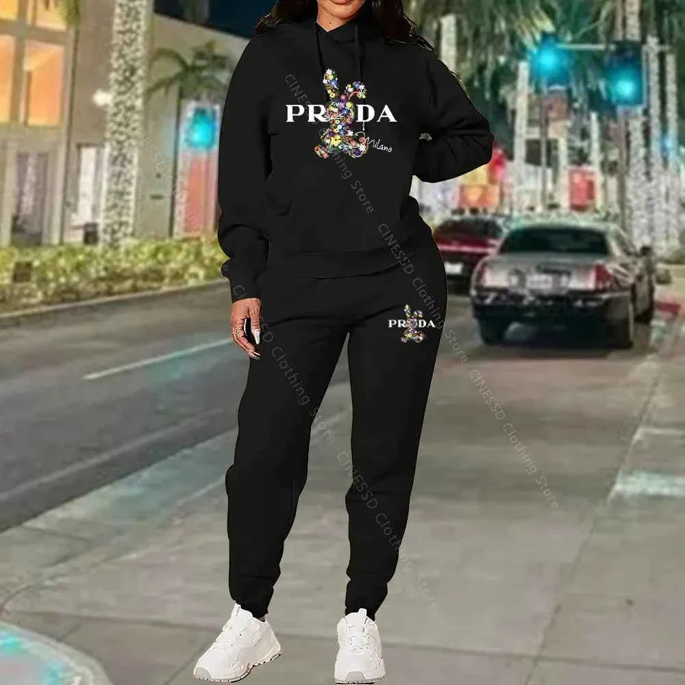 Women's 2-piece hoodie and jogger set, black with PRADA logo on chest and pants.
