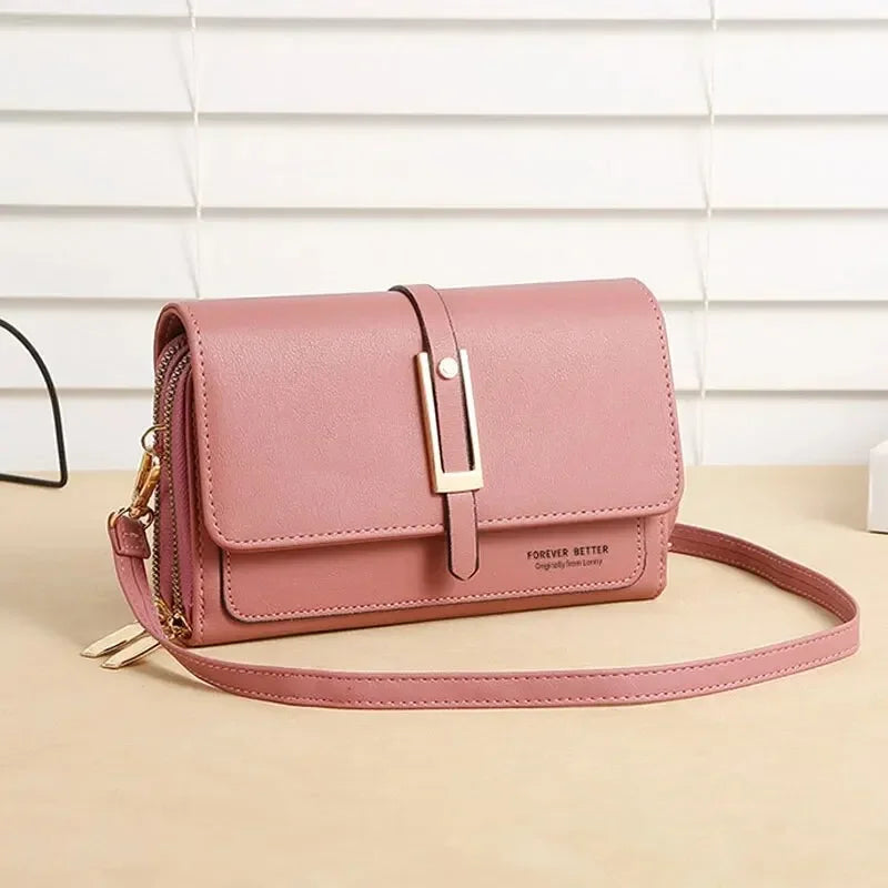 Pink crossbody bag with front flap and gold buckle, shown with long strap