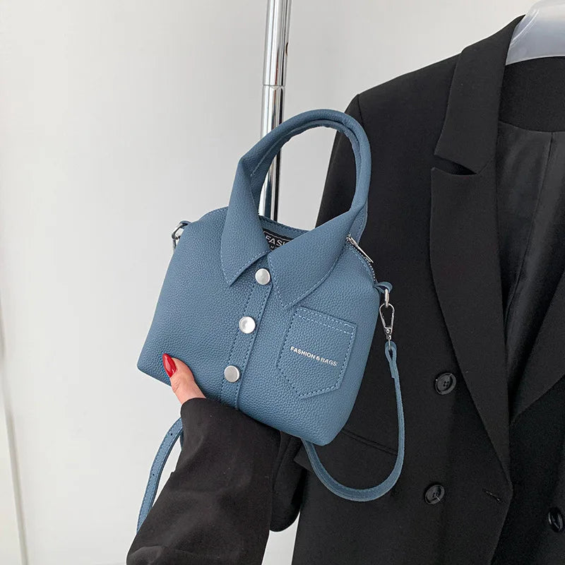 Light blue textured mini bag with button-front collar, front pocket, and shoulder strap