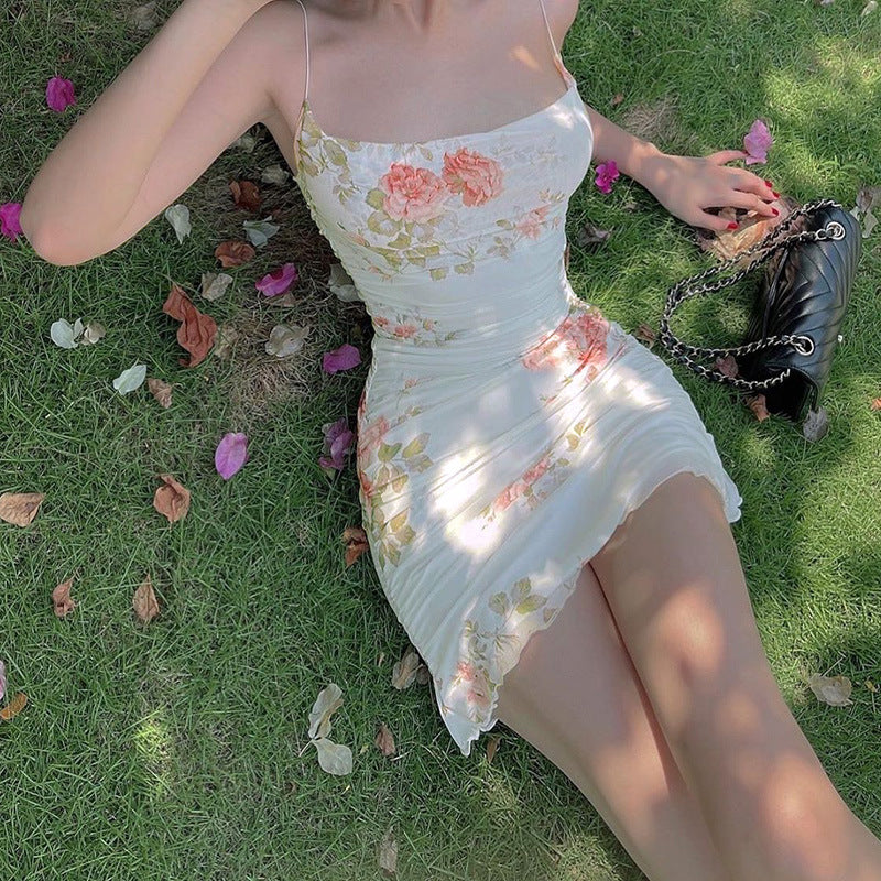White floral mini slip dress with spaghetti straps and ruched body