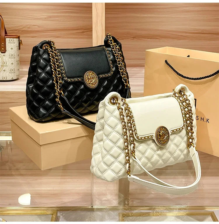 White and black quilted shoulder bags with gold chain straps and round medallion clasps