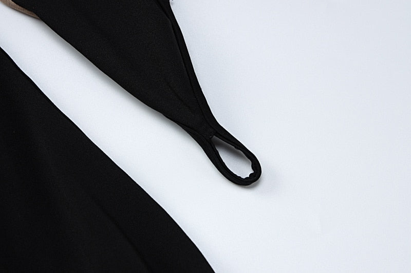 Black fabric close-up with seam and strap-like loop detail