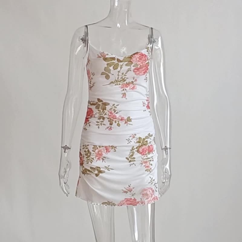 Floral slip dress on mannequin: white base with pink rose print, spaghetti straps