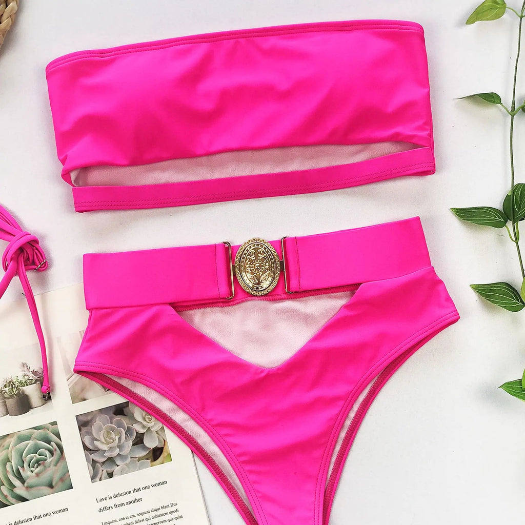 Hot pink bikini set flat lay: strapless bandeau top and high-waisted bottoms with gold clasp