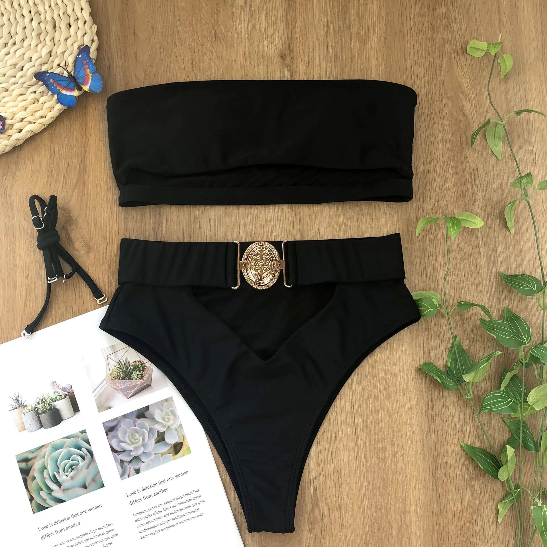 Black bandeau bikini set with high-waisted bottoms and gold medallion buckle