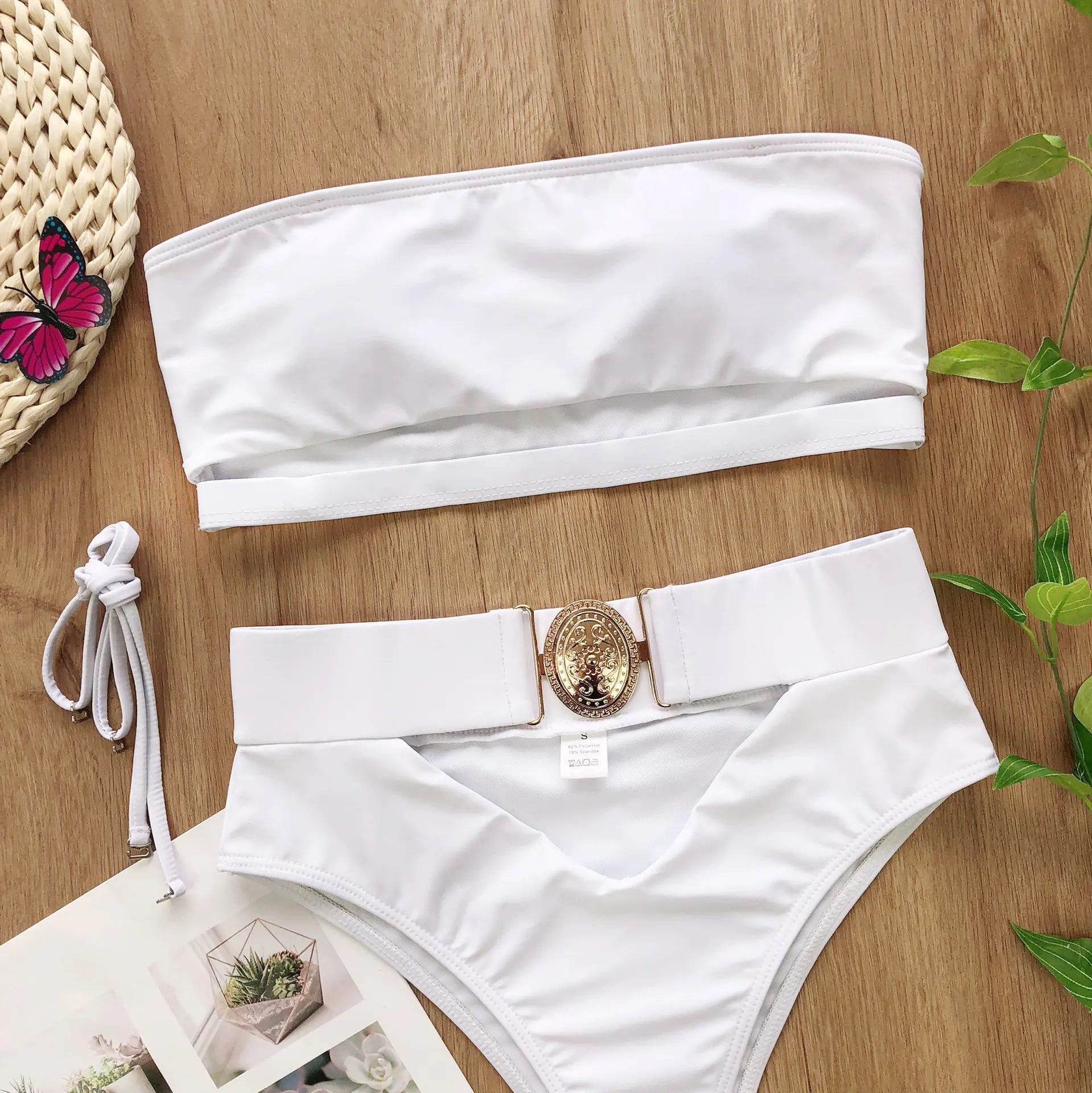 White bandeau bikini top and high-rise bottoms with gold center buckle