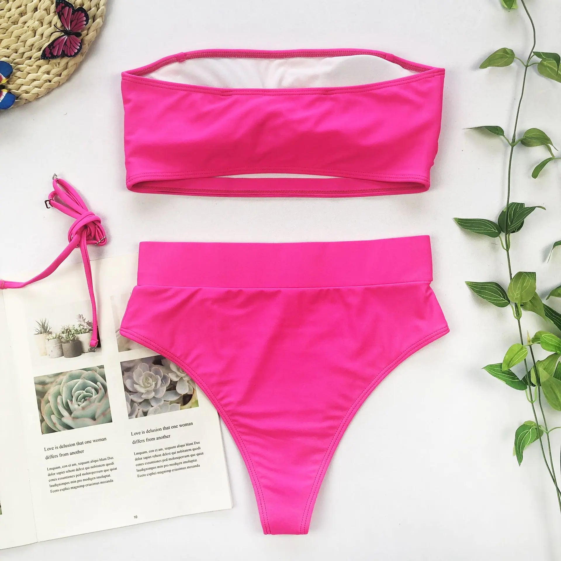 Hot pink bandeau bikini with high-waisted bottoms and gold medallion buckle